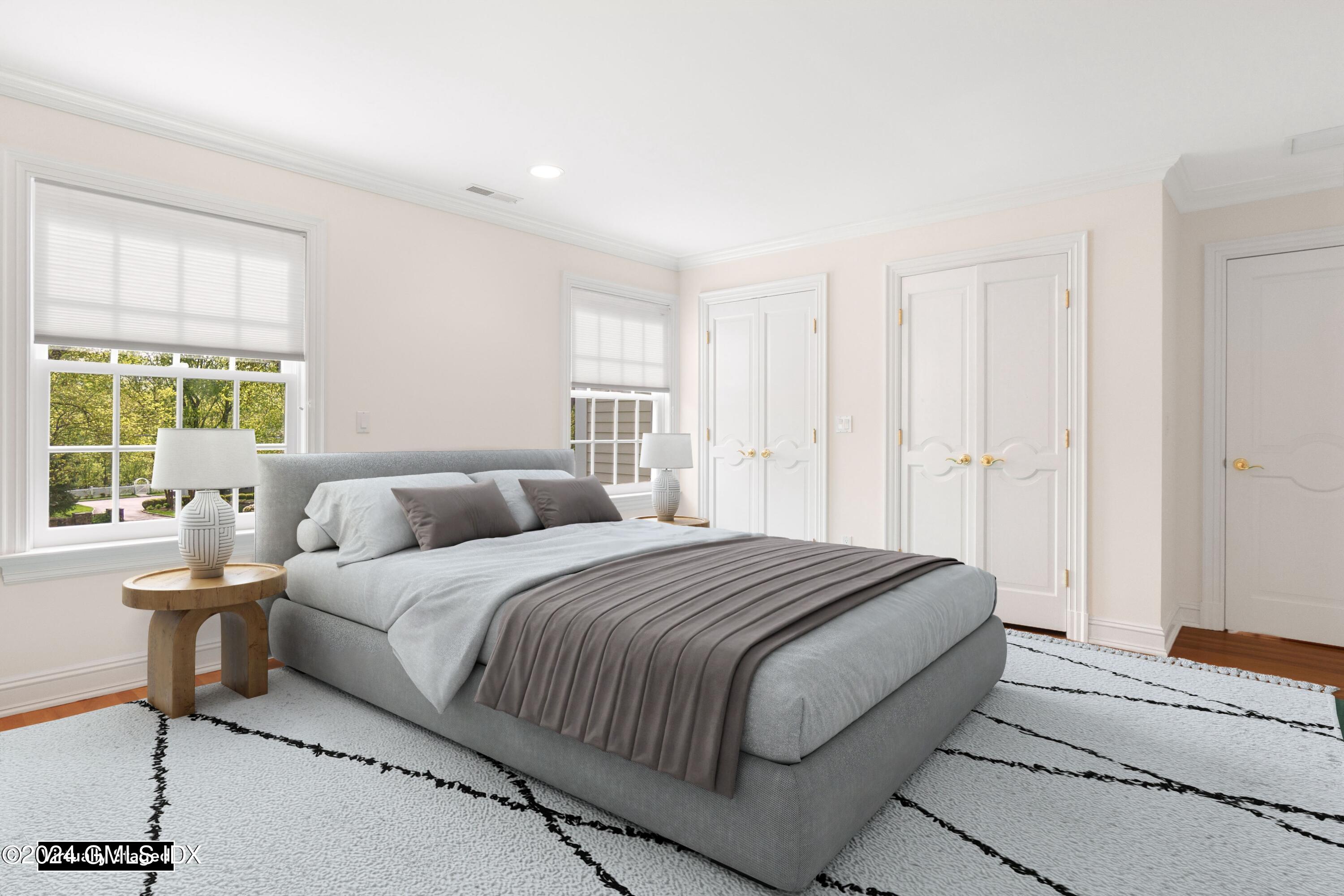 719 Ponus Ridge Road New Canaan, CT 06840 - Photo 17 of 38 a spacious bedroom with a bed and a window