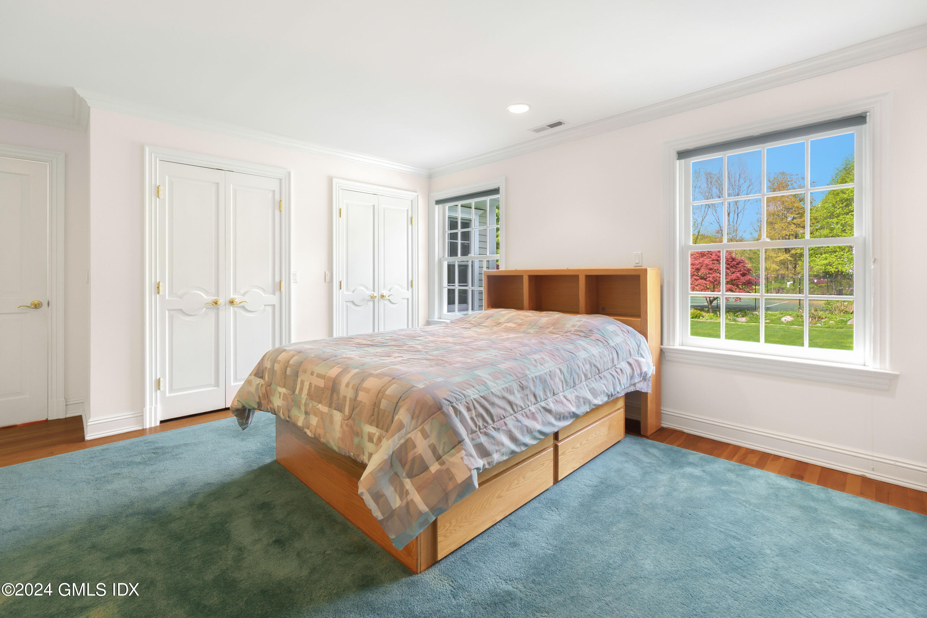 719 Ponus Ridge Road New Canaan, CT 06840 - Photo 19 of 38 a bed sitting in a spacious bedroom next to a window