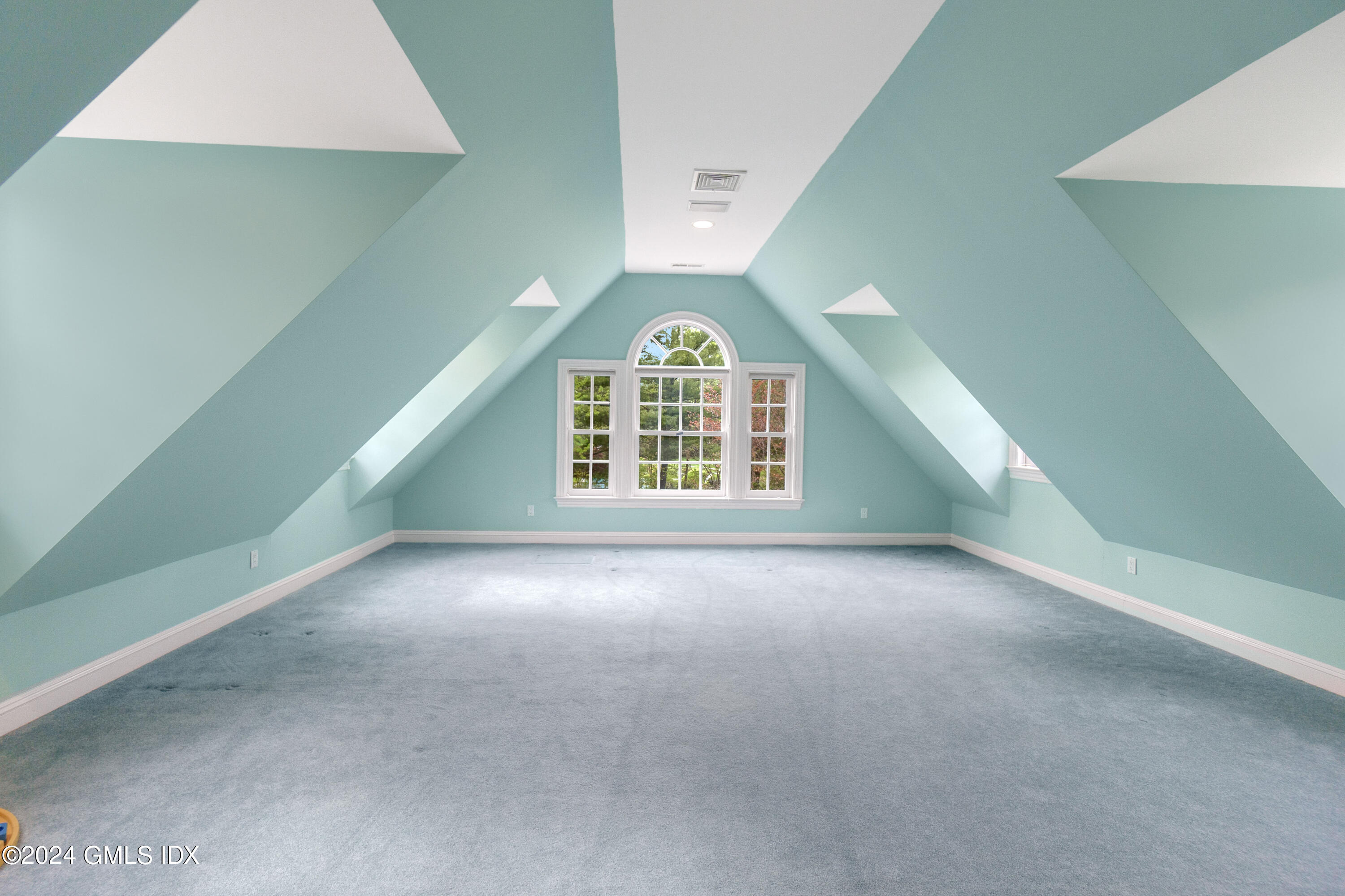 719 Ponus Ridge Road New Canaan, CT 06840 - Photo 22 of 38 an empty room with windows and ceiling fan