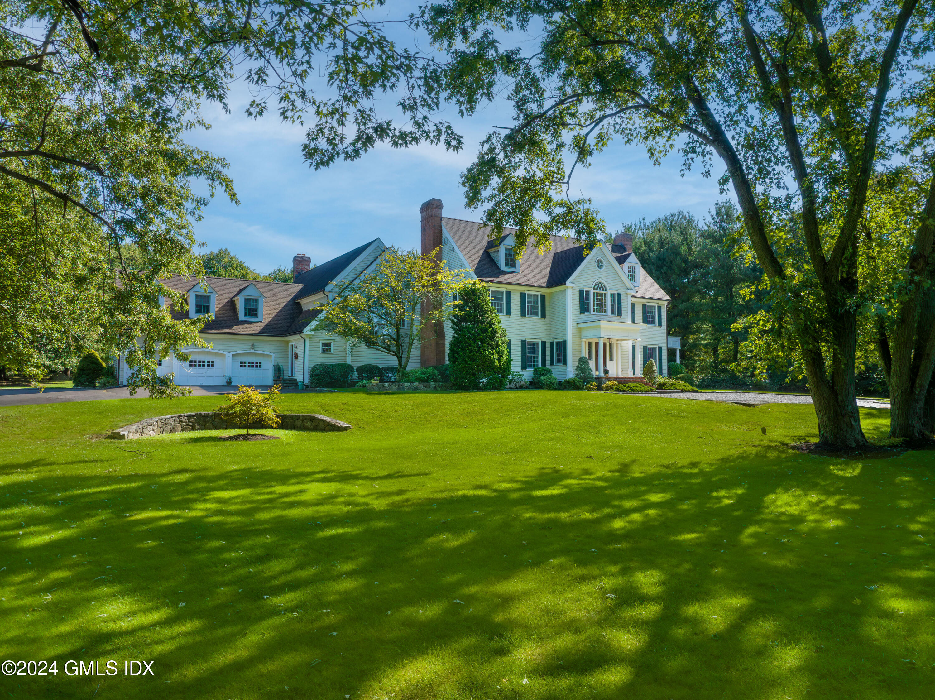 719 Ponus Ridge Road New Canaan, CT 06840 - Photo 27 of 38 a view of an house with a garden