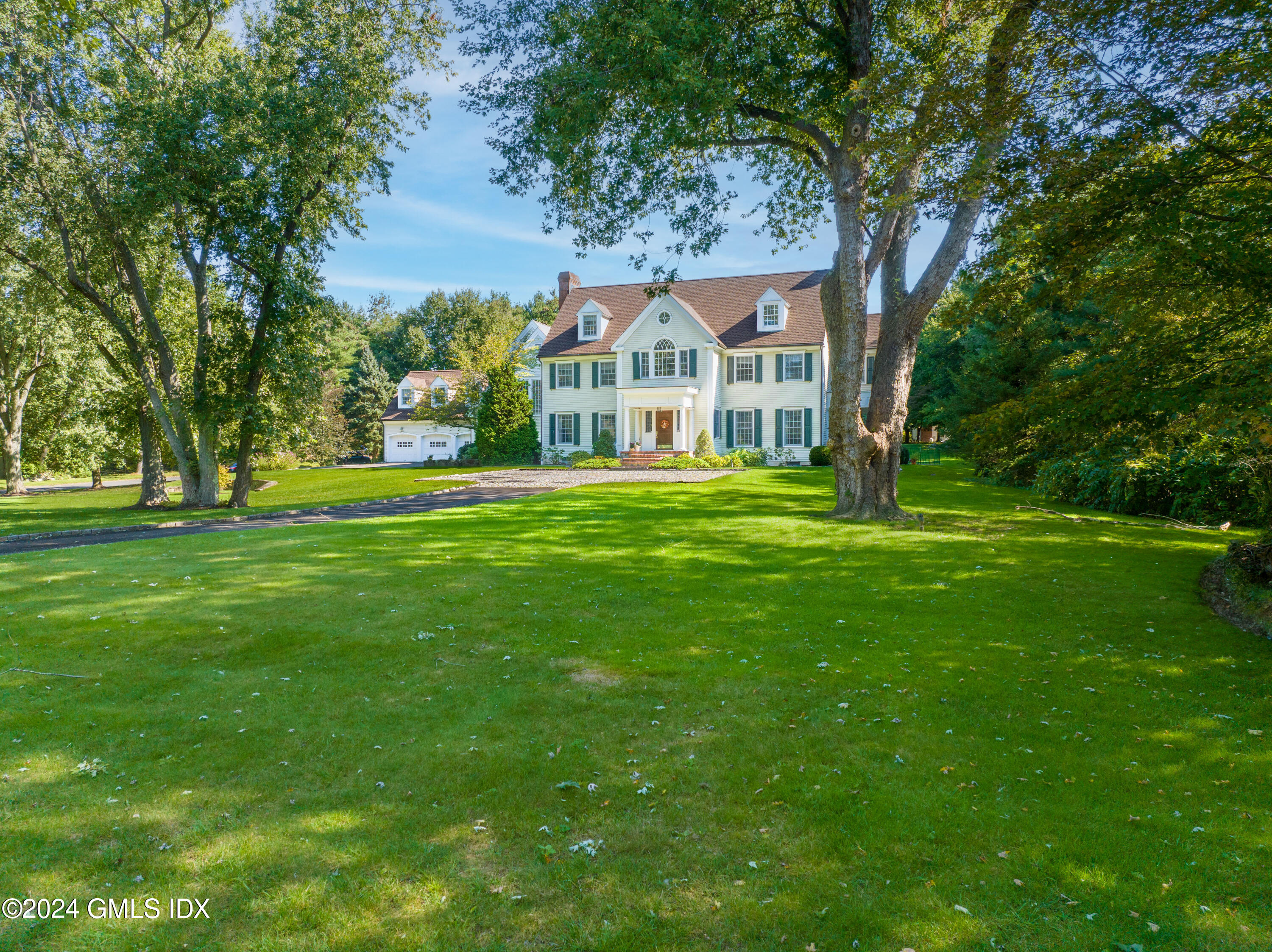 719 Ponus Ridge Road New Canaan, CT 06840 - Photo 29 of 38 a front view of a house with a yard