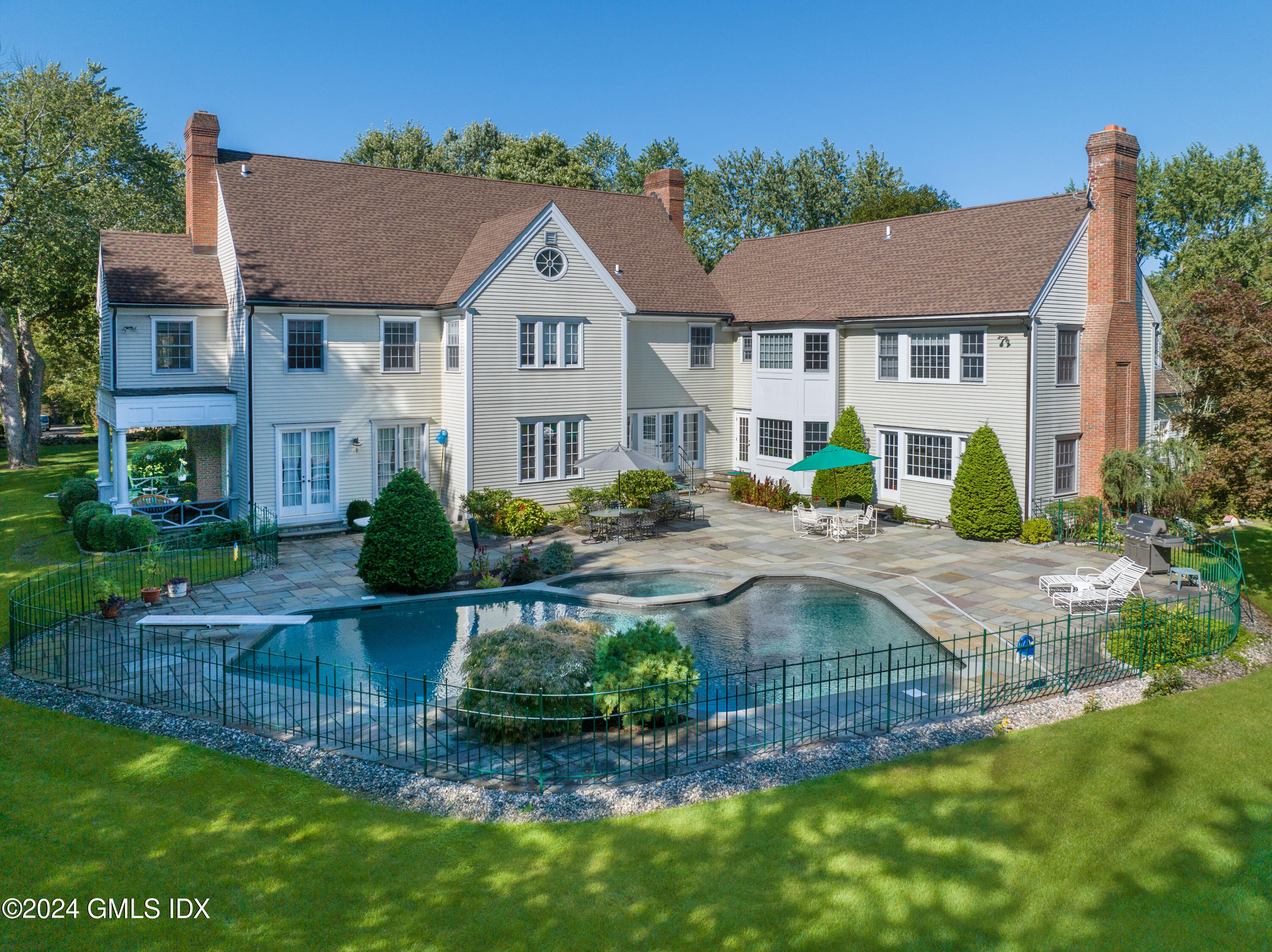 719 Ponus Ridge Road New Canaan, CT 06840 - Photo 30 of 38 a view of a house with a yard