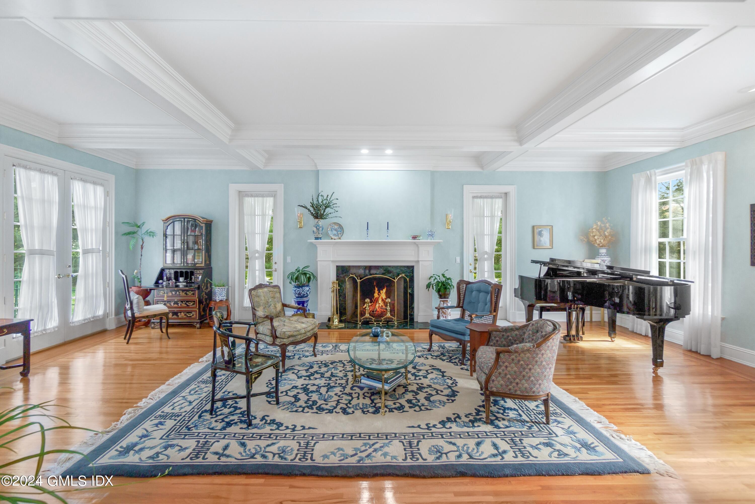 719 Ponus Ridge Road New Canaan, CT 06840 - Photo 3 of 38 a living room with furniture a fireplace and wooden floor
