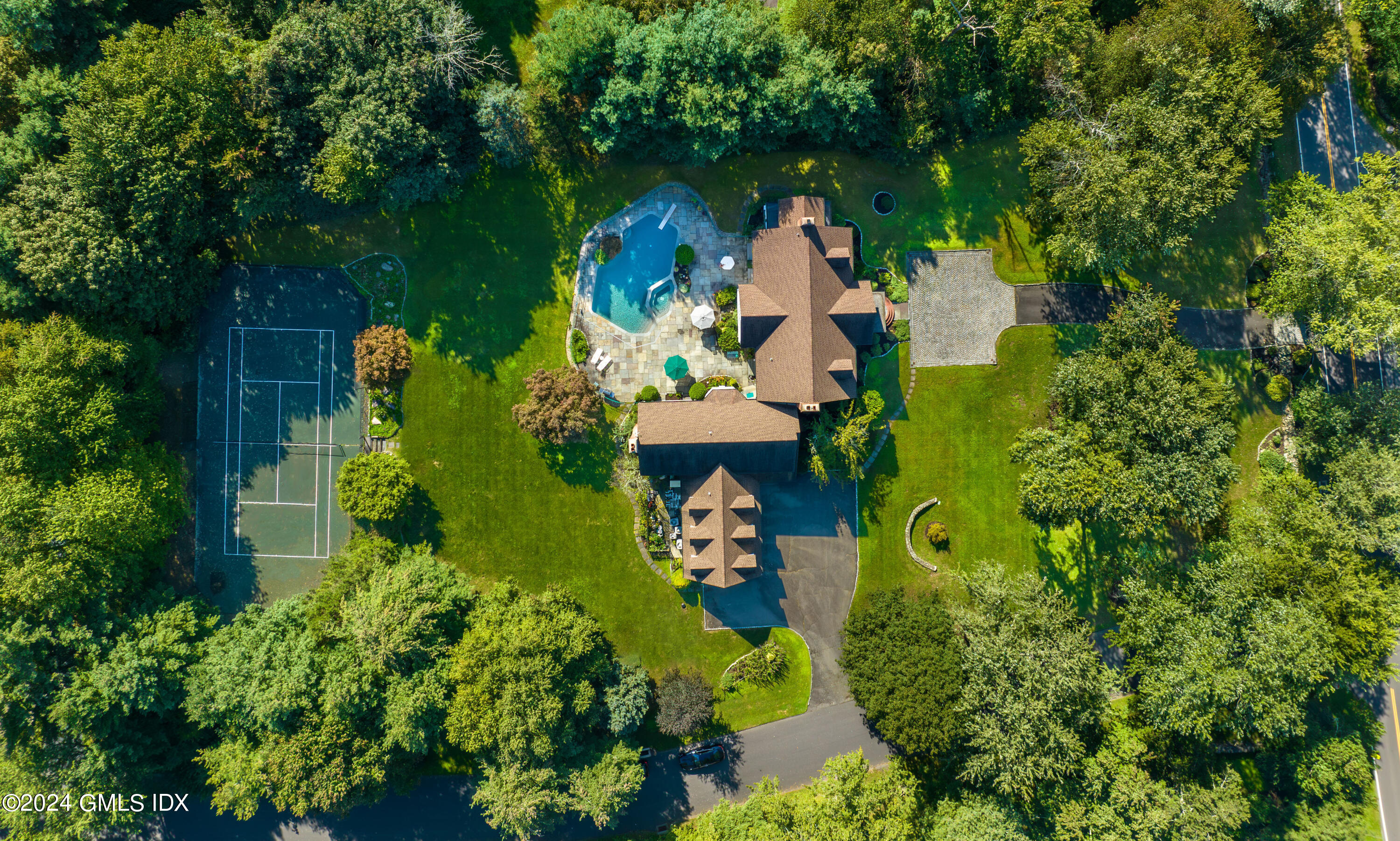 719 Ponus Ridge Road New Canaan, CT 06840 - Photo 33 of 38 an aerial view of a house with a yard swimming pool and outdoor seating