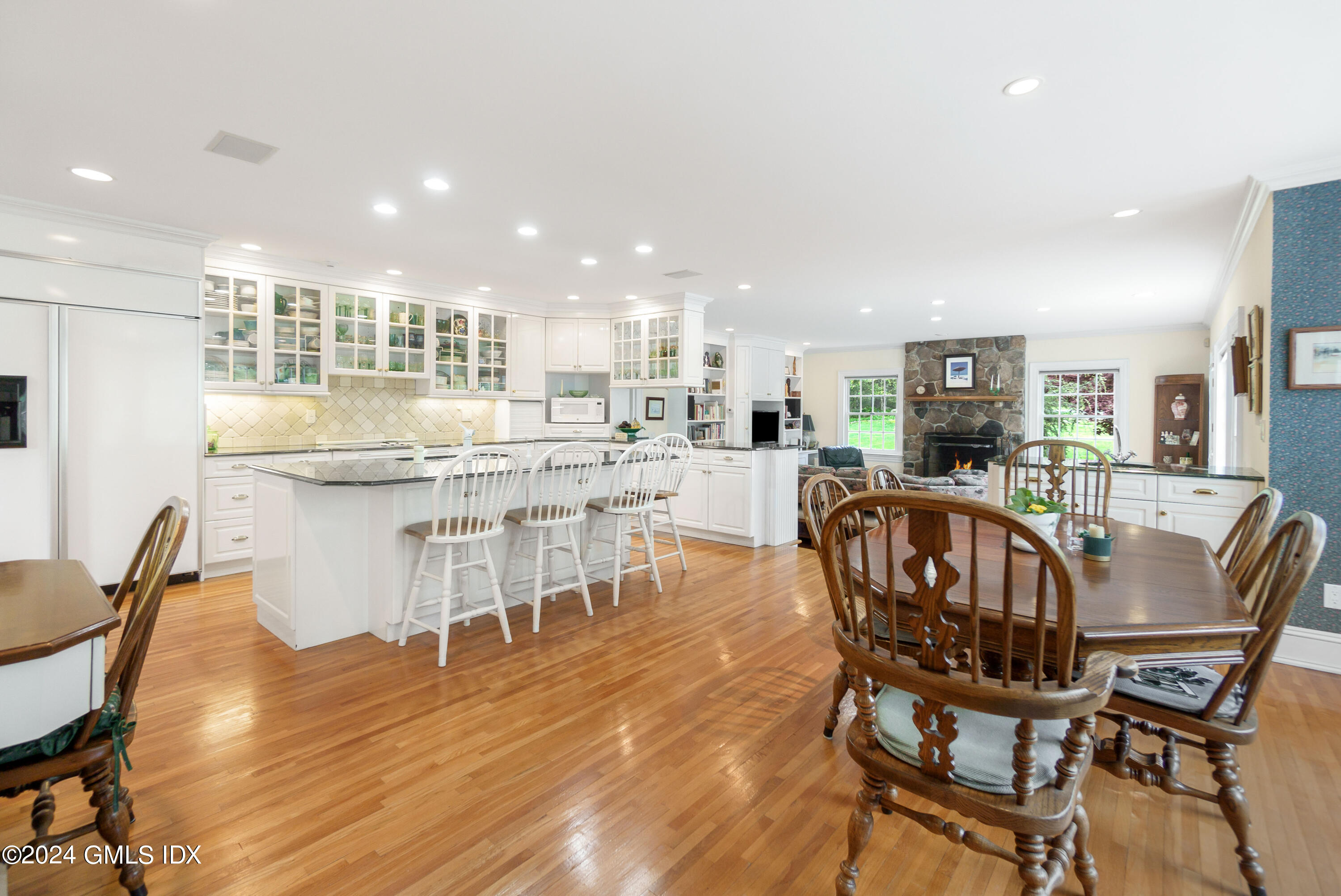 719 Ponus Ridge Road New Canaan, CT 06840 - Photo 5 of 38 a dining room with stainless steel appliances kitchen island granite countertop a dining table chairs and a refrigerator