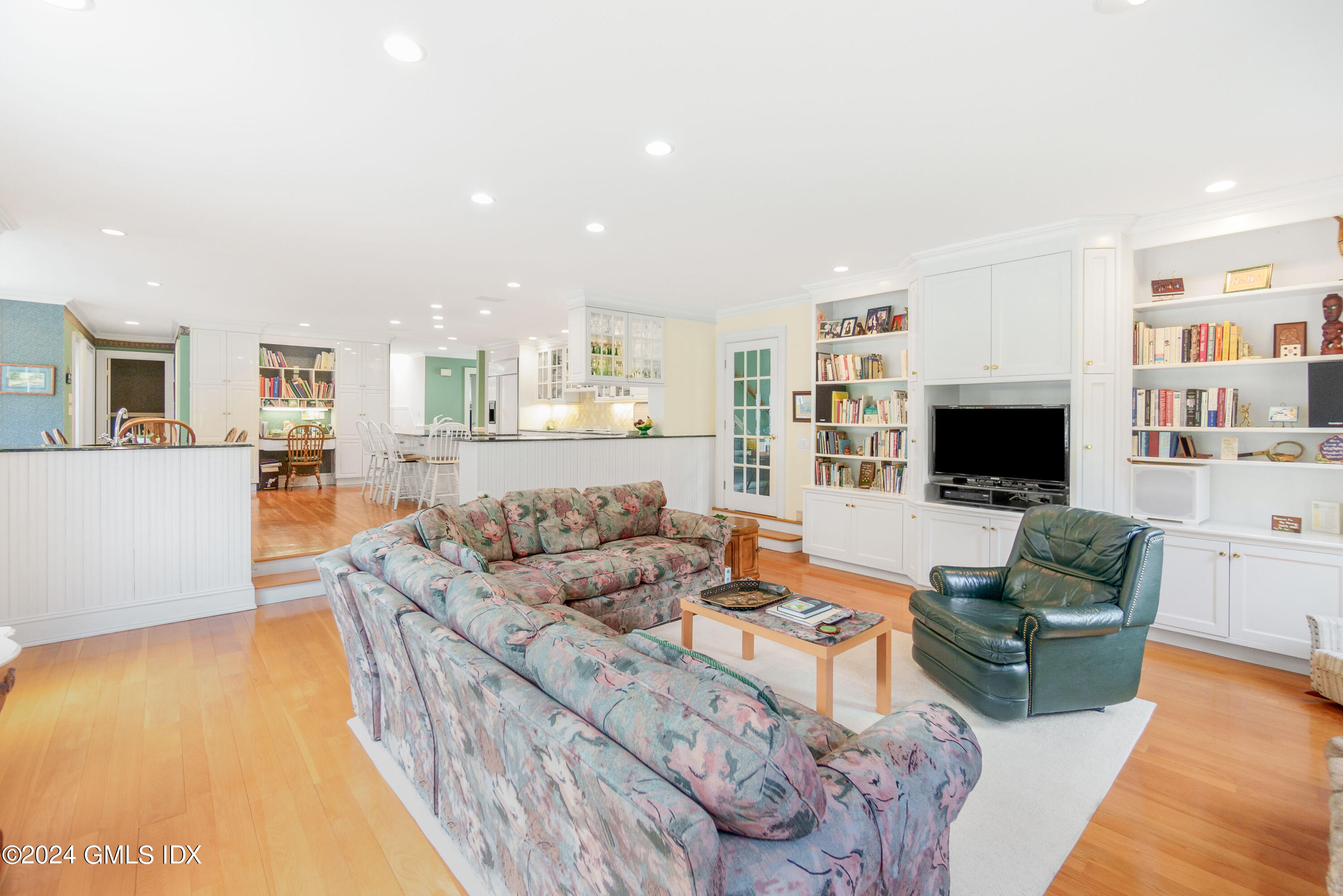 719 Ponus Ridge Road New Canaan, CT 06840 - Photo 6 of 38 a living room with fireplace furniture and a flat screen tv