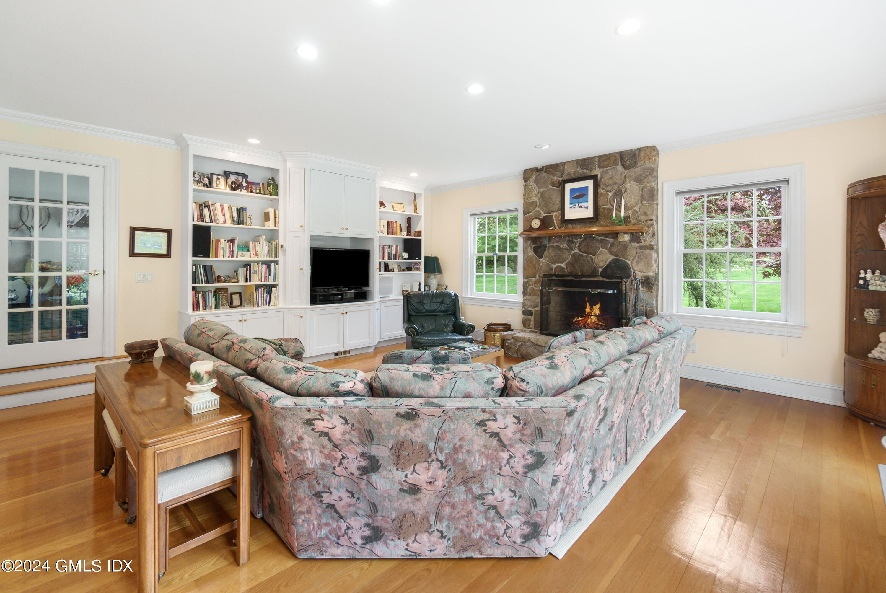 719 Ponus Ridge Road New Canaan, CT 06840 - Photo 7 of 38 a living room with fireplace furniture and a flat screen tv