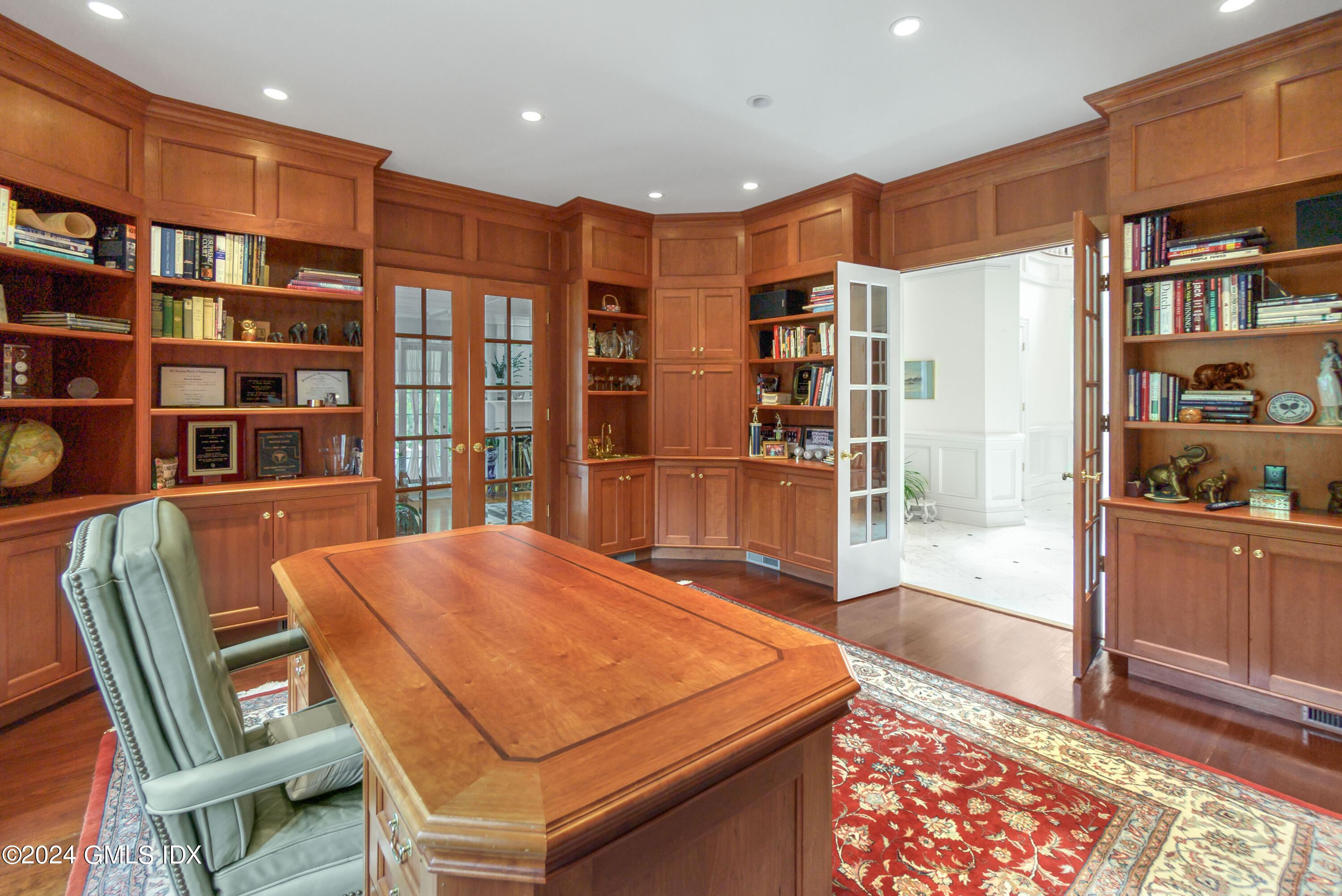 719 Ponus Ridge Road New Canaan, CT 06840 - Photo 10 of 38 a dining room with stainless steel appliances furniture and a book shelf