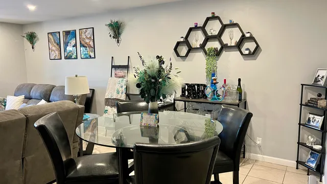 a dining room with furniture and wooden floor