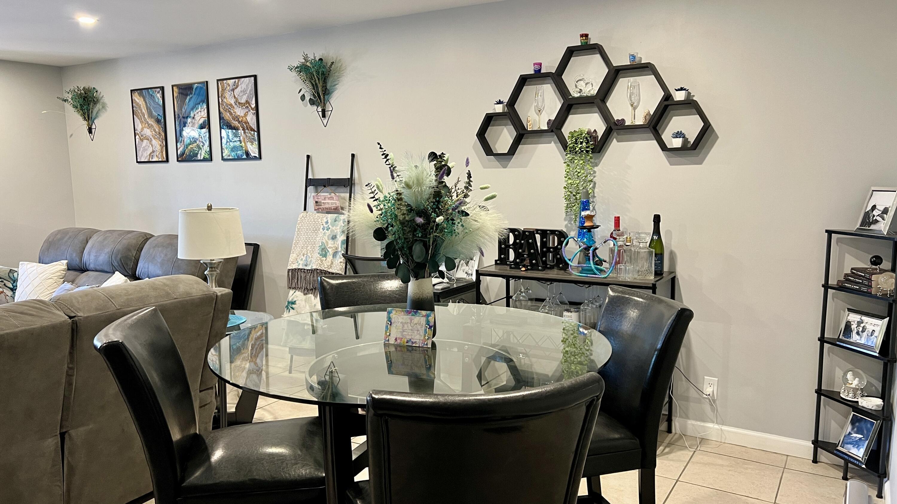 140 South Cypress Road, Unit 123 Pompano Beach, FL 33060 - Photo 12 of 23 a dining room with furniture and wooden floor