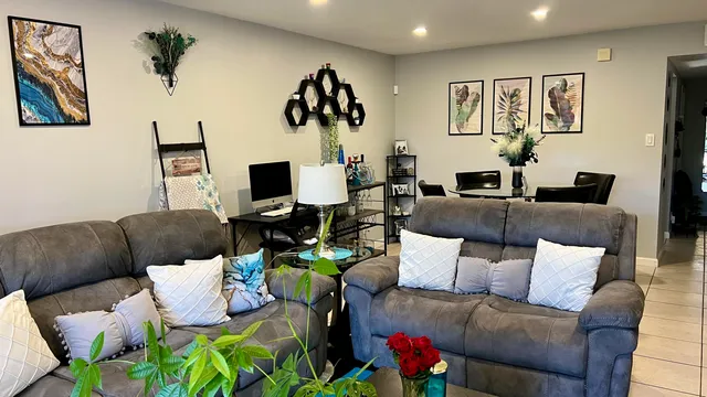 a living room with furniture and a flat screen tv