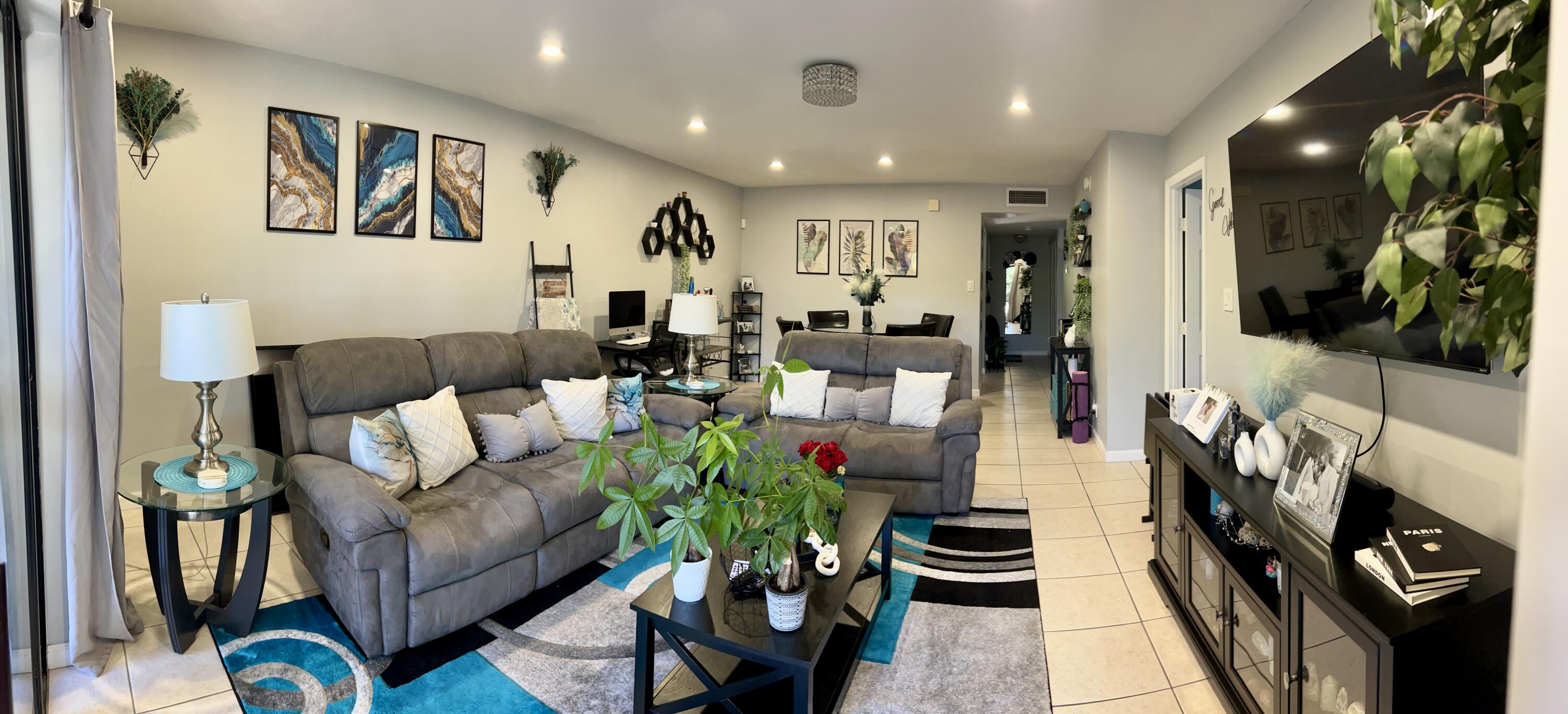 140 South Cypress Road, Unit 123 Pompano Beach, FL 33060 - Photo 22 of 23 a living room with furniture and a flat screen tv