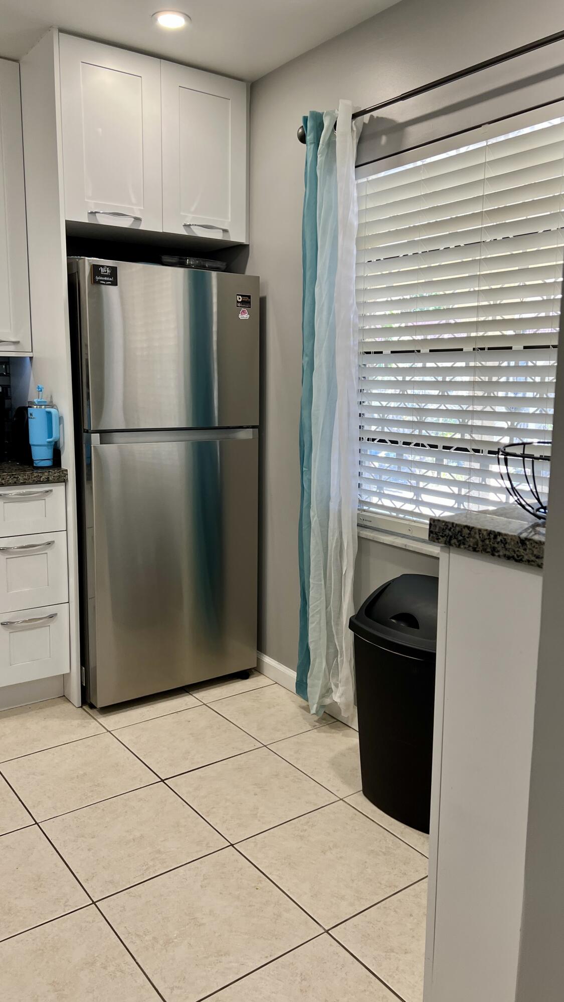 140 South Cypress Road, Unit 123 Pompano Beach, FL 33060 - Photo 4 of 23 a kitchen with stainless steel appliances granite countertop a refrigerator and a stove