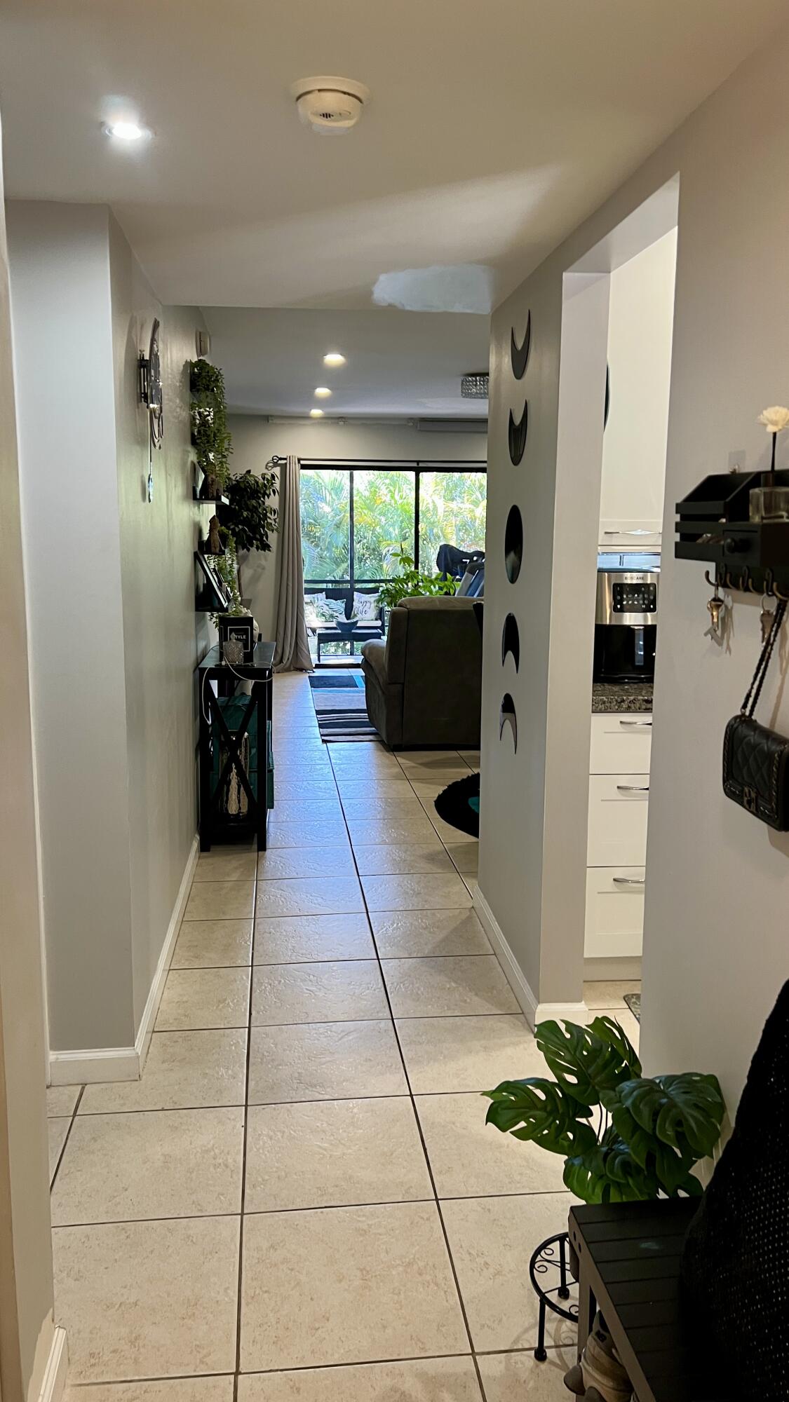140 South Cypress Road, Unit 123 Pompano Beach, FL 33060 - Photo 6 of 23 a living room with stainless steel appliances furniture a fireplace and a potted plant