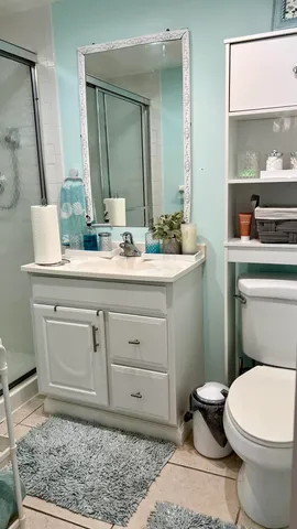a bathroom with a sink a toilet and mirror