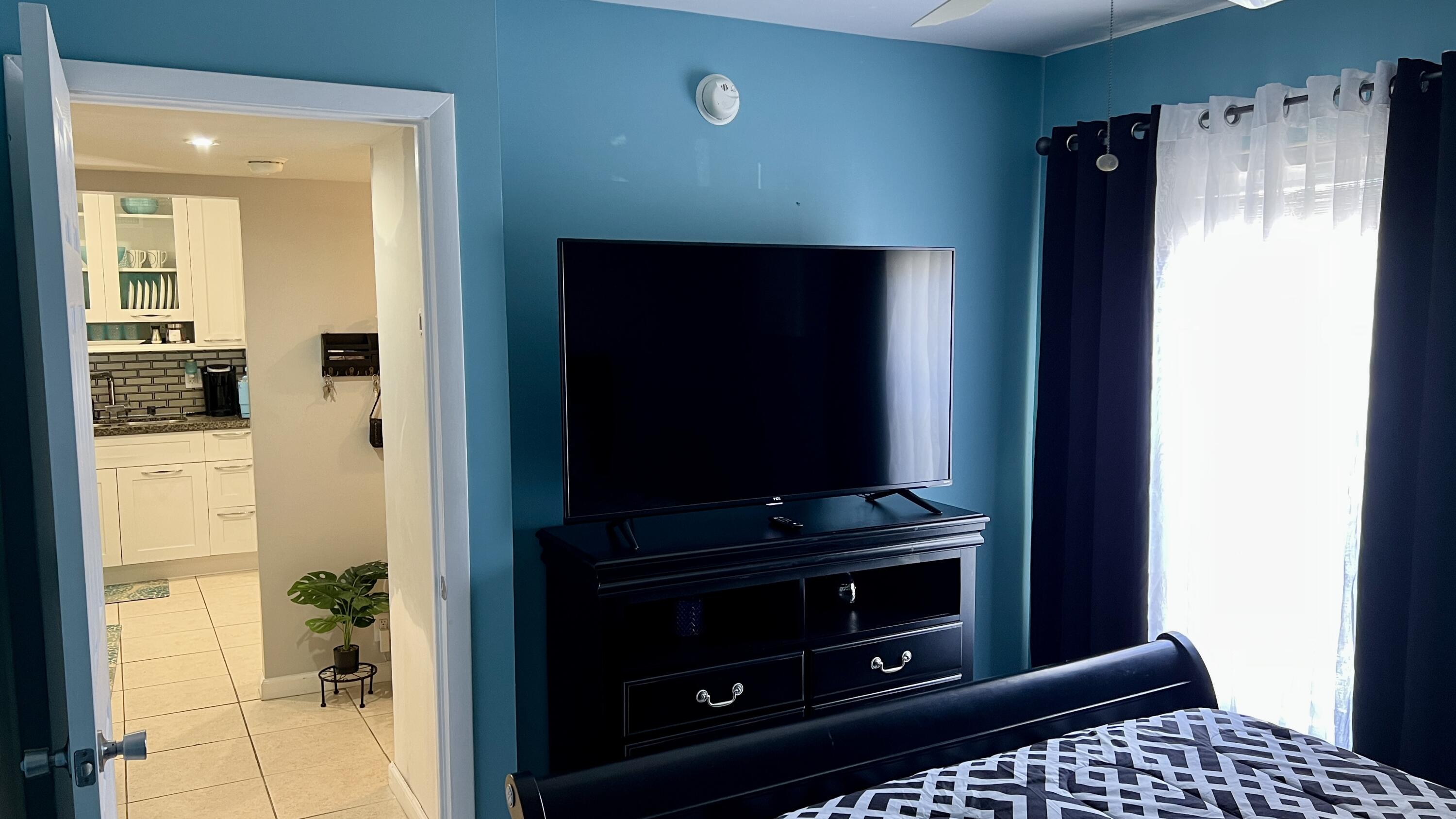 140 South Cypress Road, Unit 123 Pompano Beach, FL 33060 - Photo 9 of 23 a living room with a flat screen tv and a fireplace