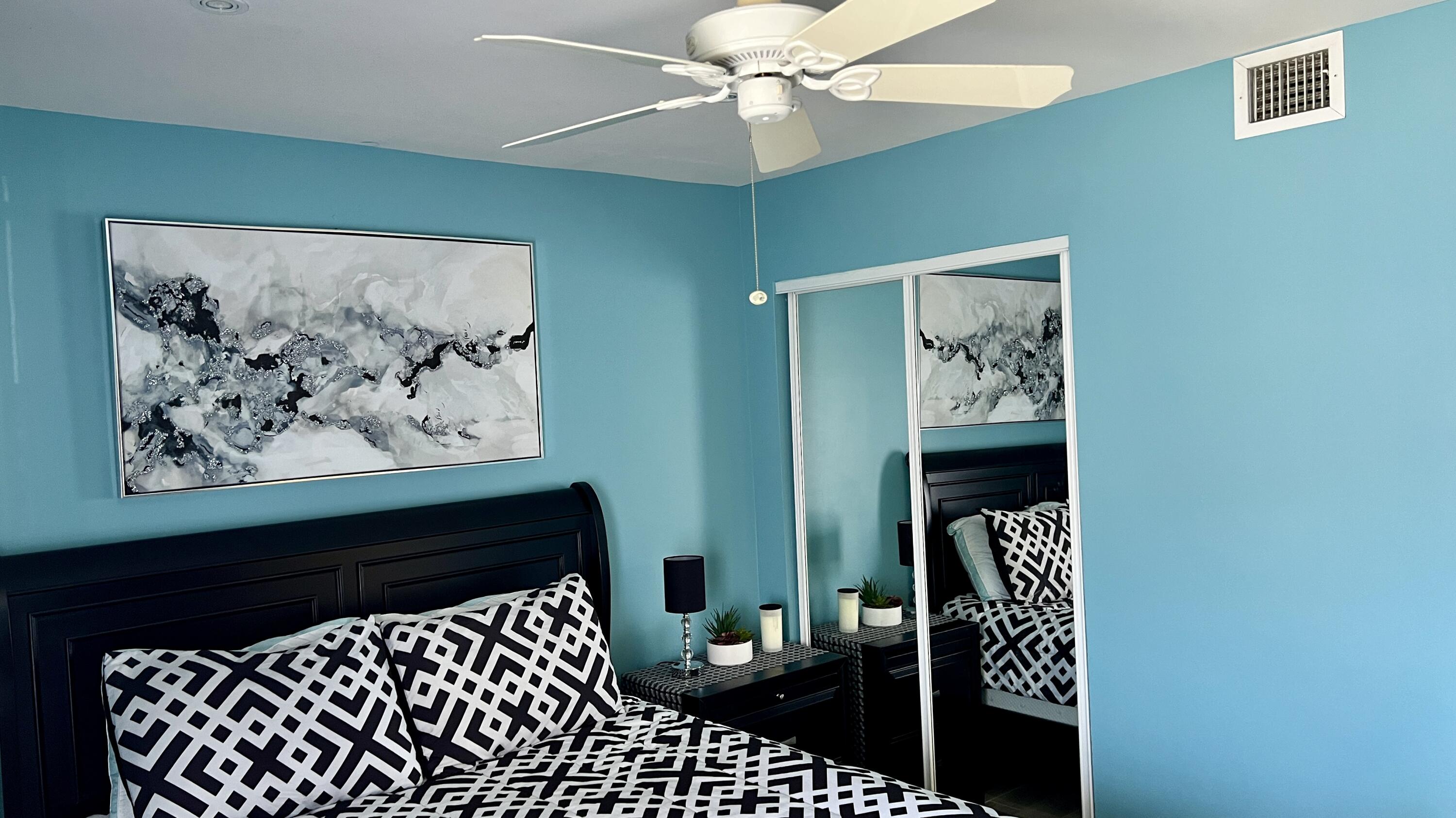 140 South Cypress Road, Unit 123 Pompano Beach, FL 33060 - Photo 10 of 23 a bedroom with a bed and a painting on the wall