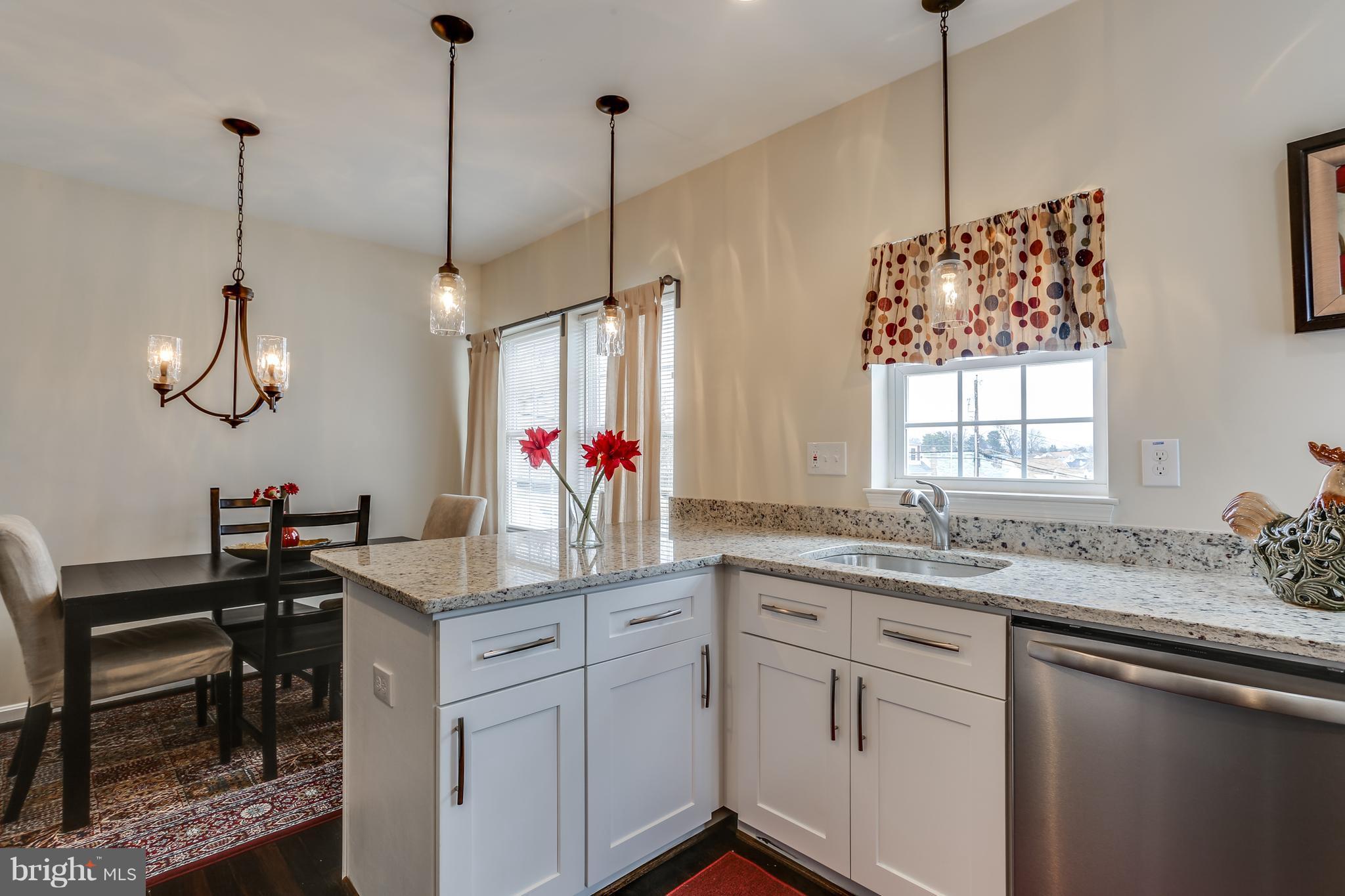 7907 Underhill Road Baltimore, MD 21237 - Photo 11 of 27 a kitchen that has a sink stove and cabinets