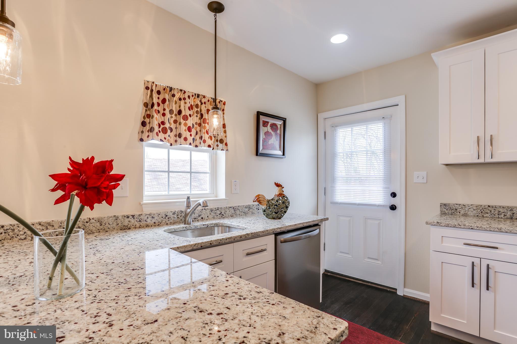 7907 Underhill Road Baltimore, MD 21237 - Photo 13 of 27 a kitchen with stainless steel appliances kitchen island granite countertop a sink and cabinets