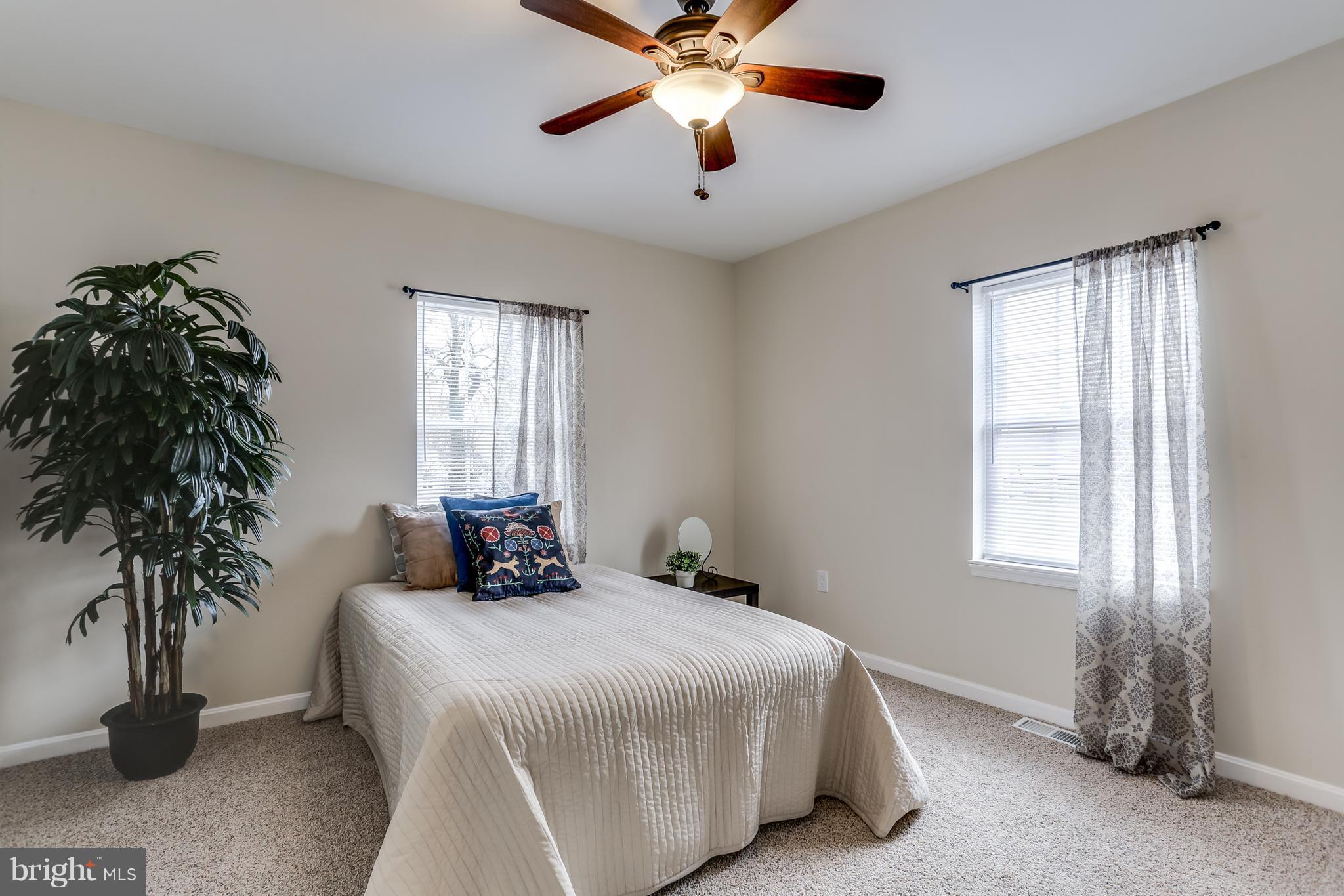 7907 Underhill Road Baltimore, MD 21237 - Photo 15 of 27 a bedroom with a bed and a window