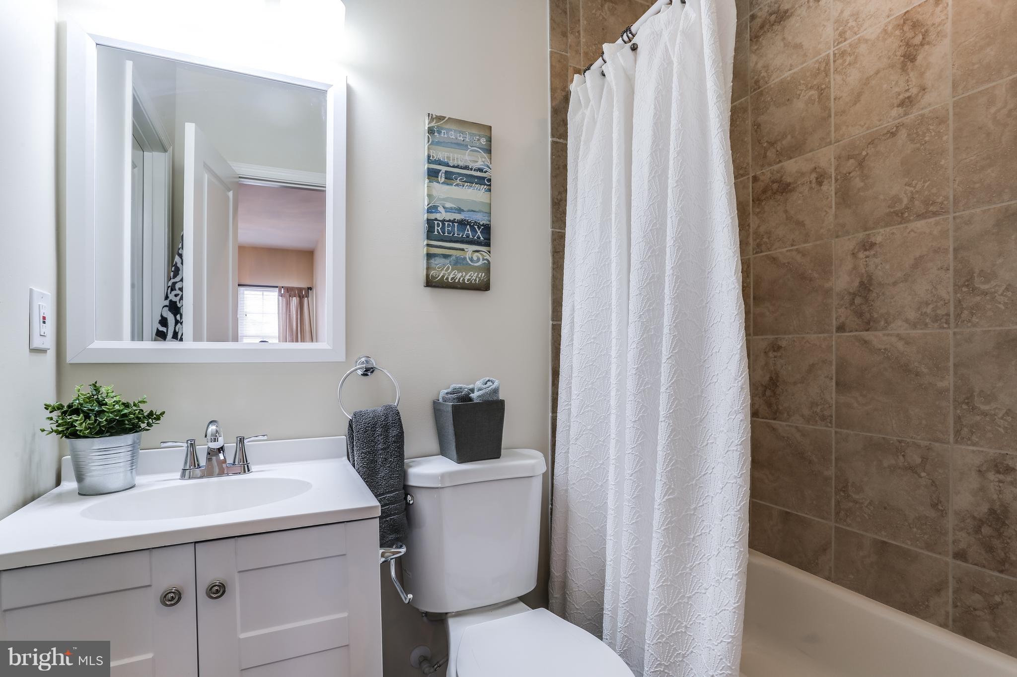 7907 Underhill Road Baltimore, MD 21237 - Photo 17 of 27 a bathroom with a sink toilet and shower