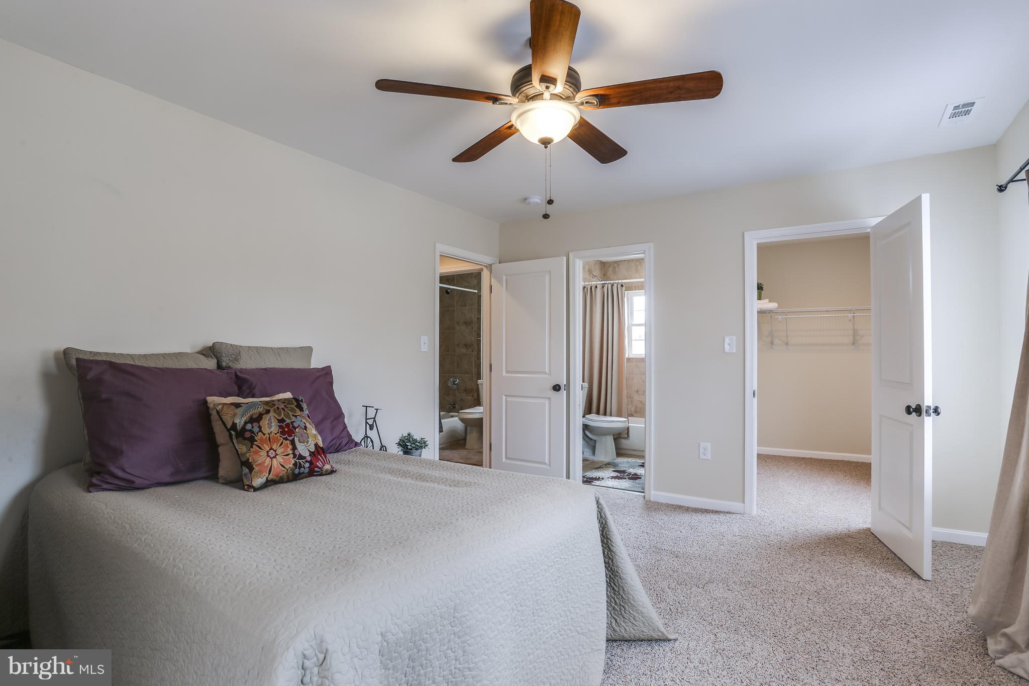 7907 Underhill Road Baltimore, MD 21237 - Photo 18 of 27 a bedroom with a bed and a ceiling fan