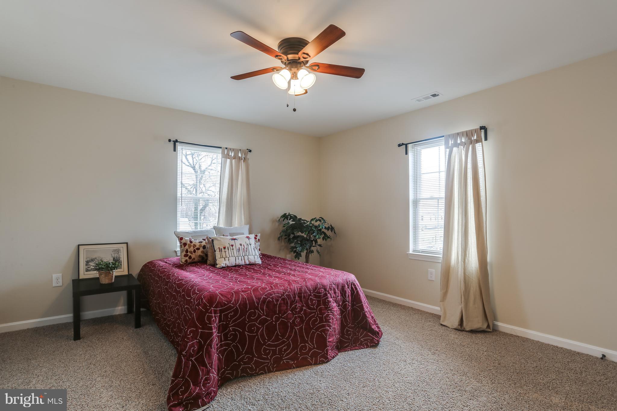7907 Underhill Road Baltimore, MD 21237 - Photo 23 of 27 a spacious bedroom with a bed and a chandelier