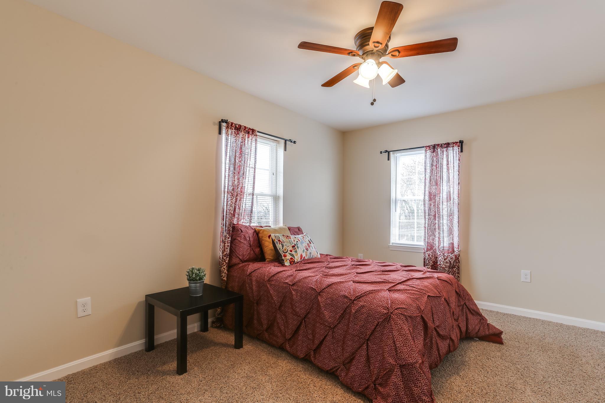 7907 Underhill Road Baltimore, MD 21237 - Photo 24 of 27 a bedroom with a bed and a chandelier