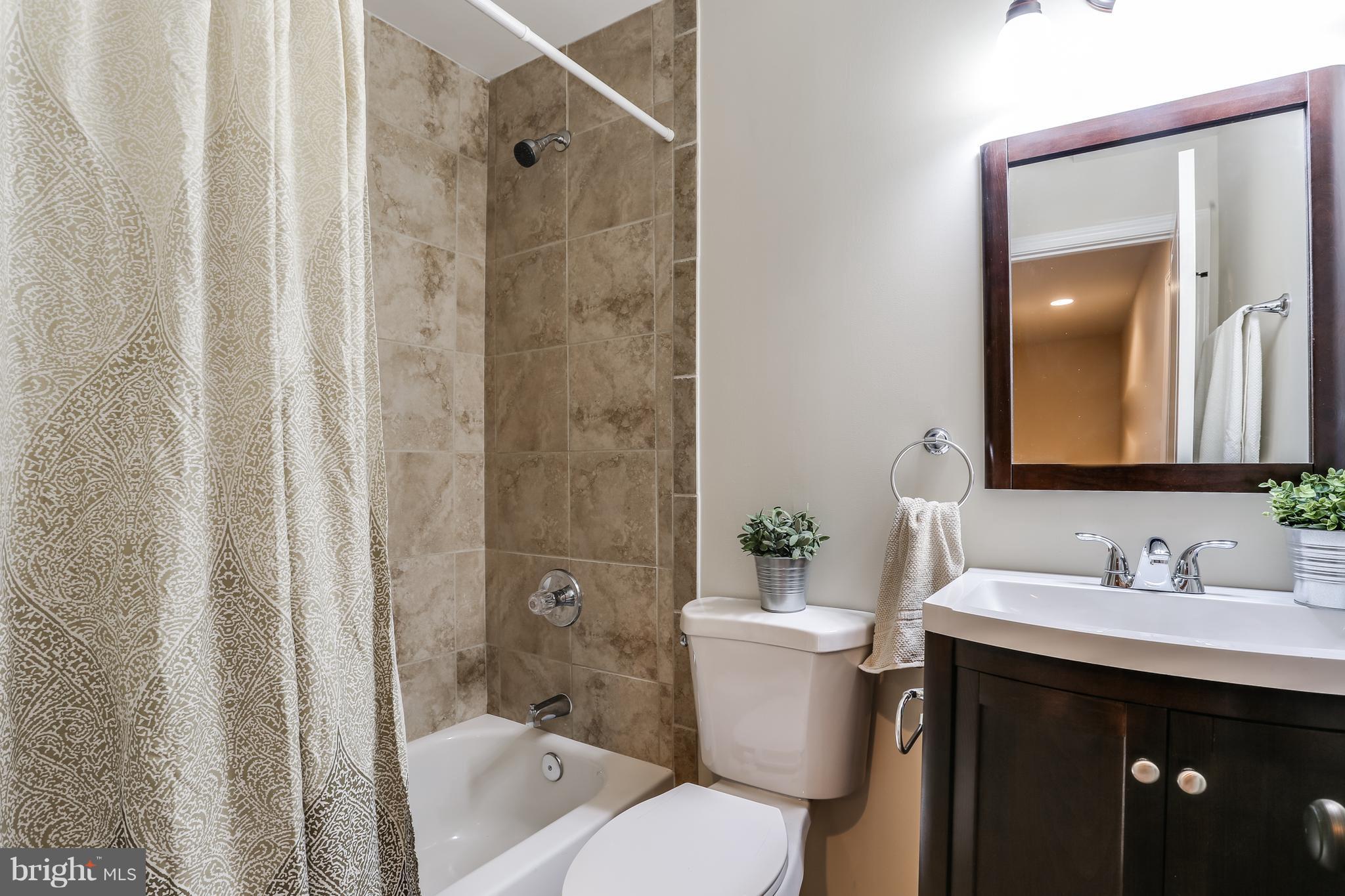7907 Underhill Road Baltimore, MD 21237 - Photo 25 of 27 a bathroom with a sink toilet and shower