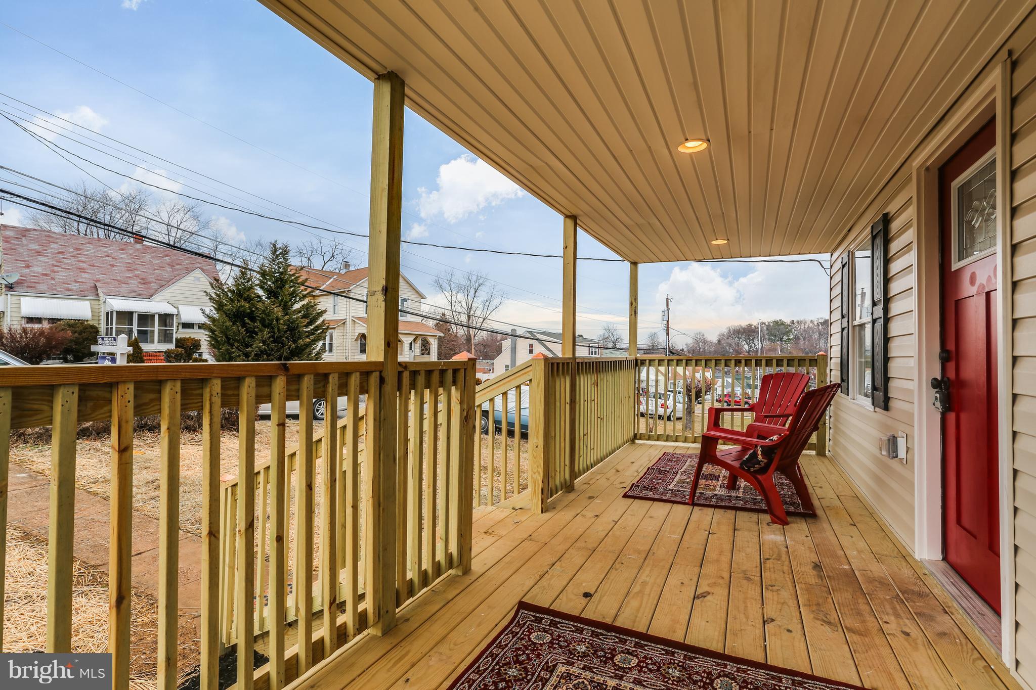 7907 Underhill Road Baltimore, MD 21237 - Photo 4 of 27 a balcony with wooden floor and outdoor seating