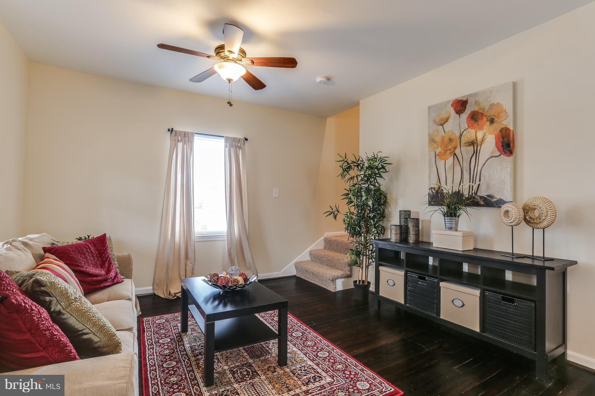 7907 Underhill Road Baltimore, MD 21237 - Photo 5 of 27 a living room with furniture and a chandelier