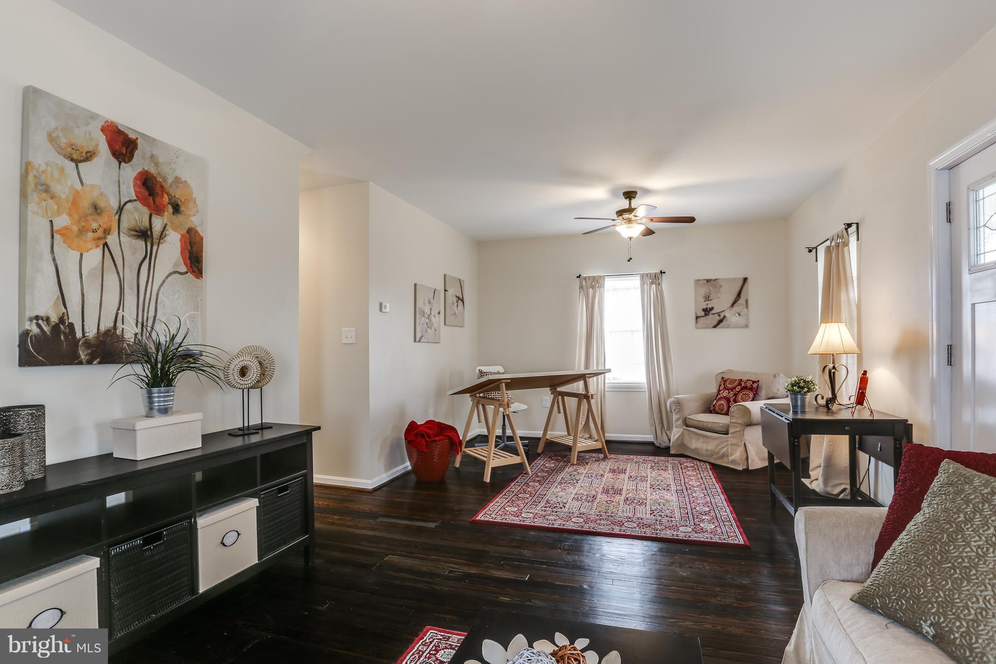7907 Underhill Road Baltimore, MD 21237 - Photo 9 of 27 a living room with furniture and a chandelier