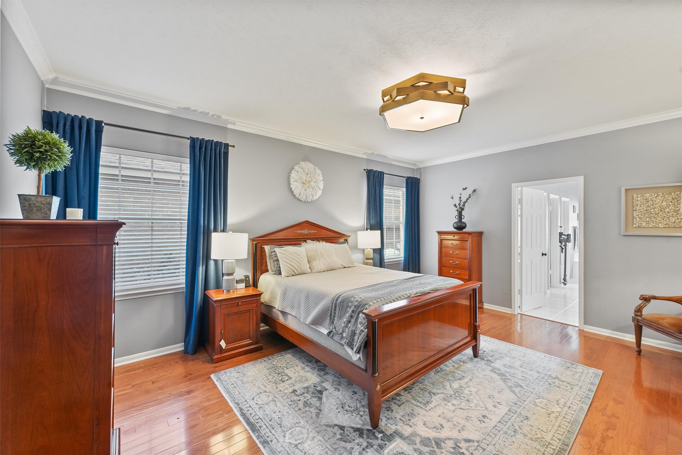 3006 Rothbury Drive Pearland, TX 77584 - Photo 13 of 28 a bedroom with a bed and a table with wooden floor