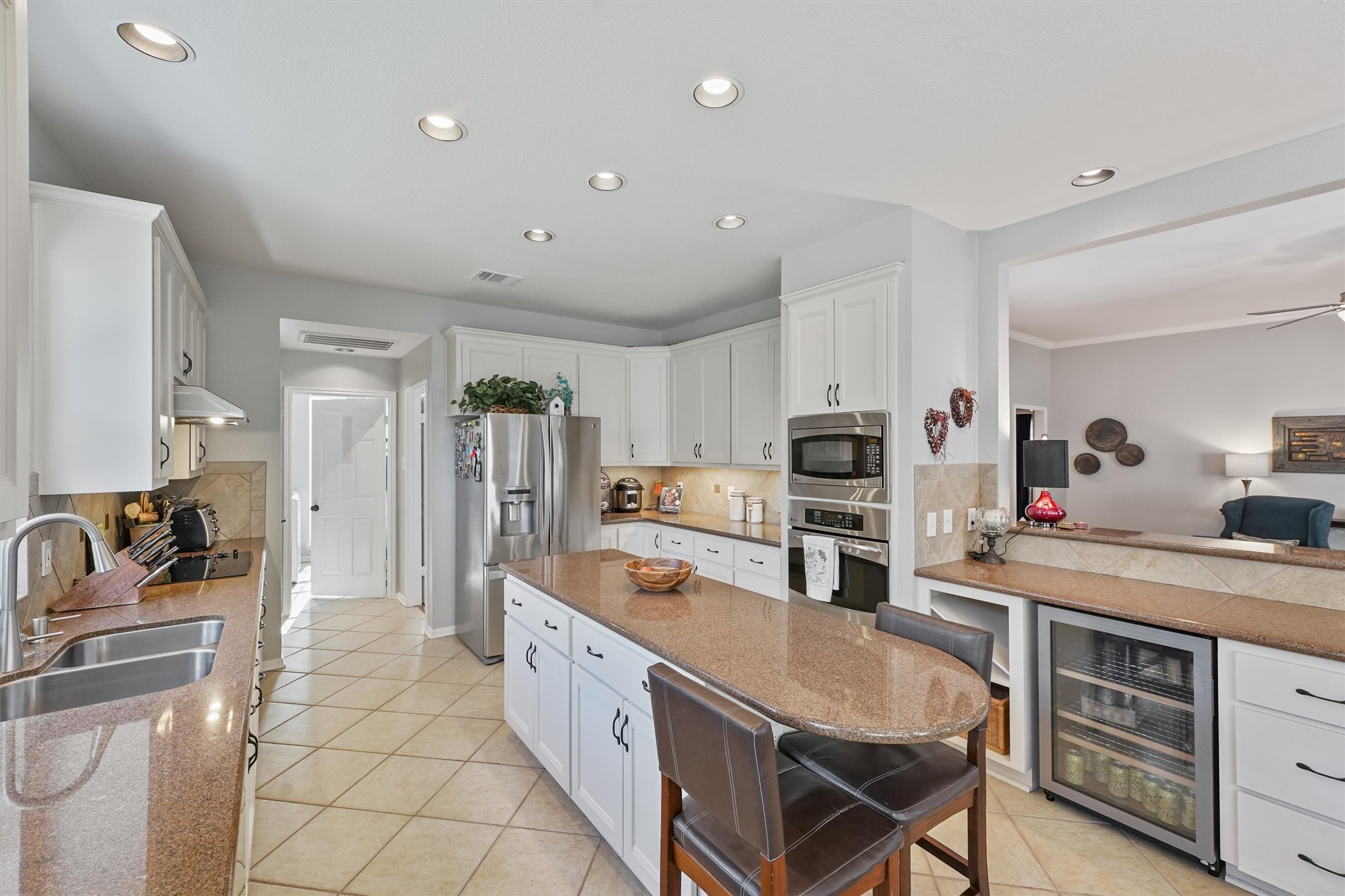 3006 Rothbury Drive Pearland, TX 77584 - Photo 10 of 28 a kitchen with stainless steel appliances granite countertop a stove refrigerator and cabinets