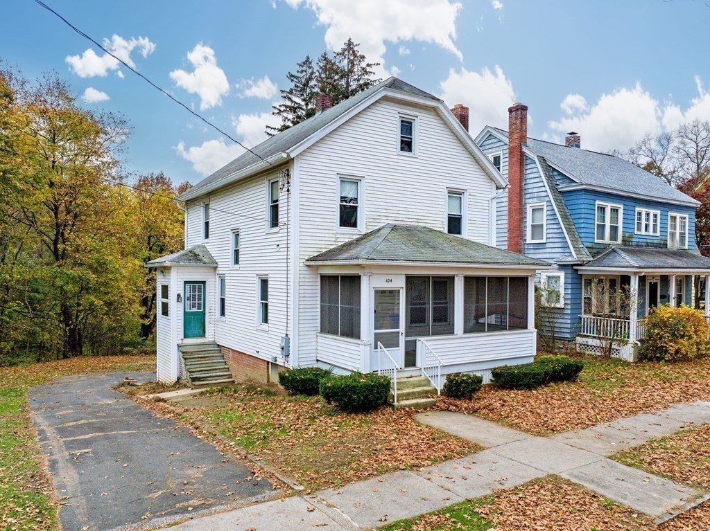 104 Eleanor Road Springfield, MA 01108 - Photo 1 of 33 a view of a white house with a yard and large tree and plants
