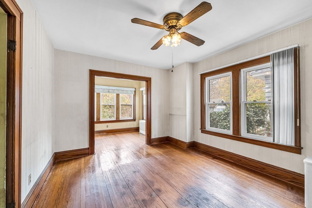104 Eleanor Road Springfield, MA 01108 - Photo 11 of 33 an empty room with wooden floor and windows