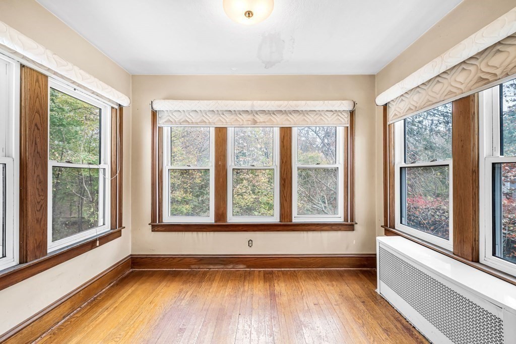 104 Eleanor Road Springfield, MA 01108 - Photo 14 of 33 a view of an empty room with a window and wooden floor