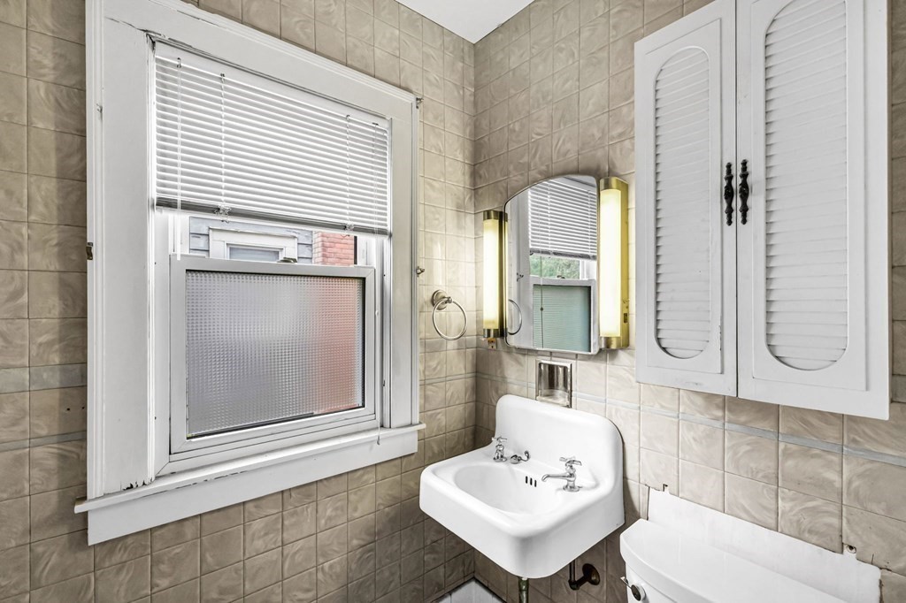 104 Eleanor Road Springfield, MA 01108 - Photo 15 of 33 a bathroom with a sink a toilet and mirror