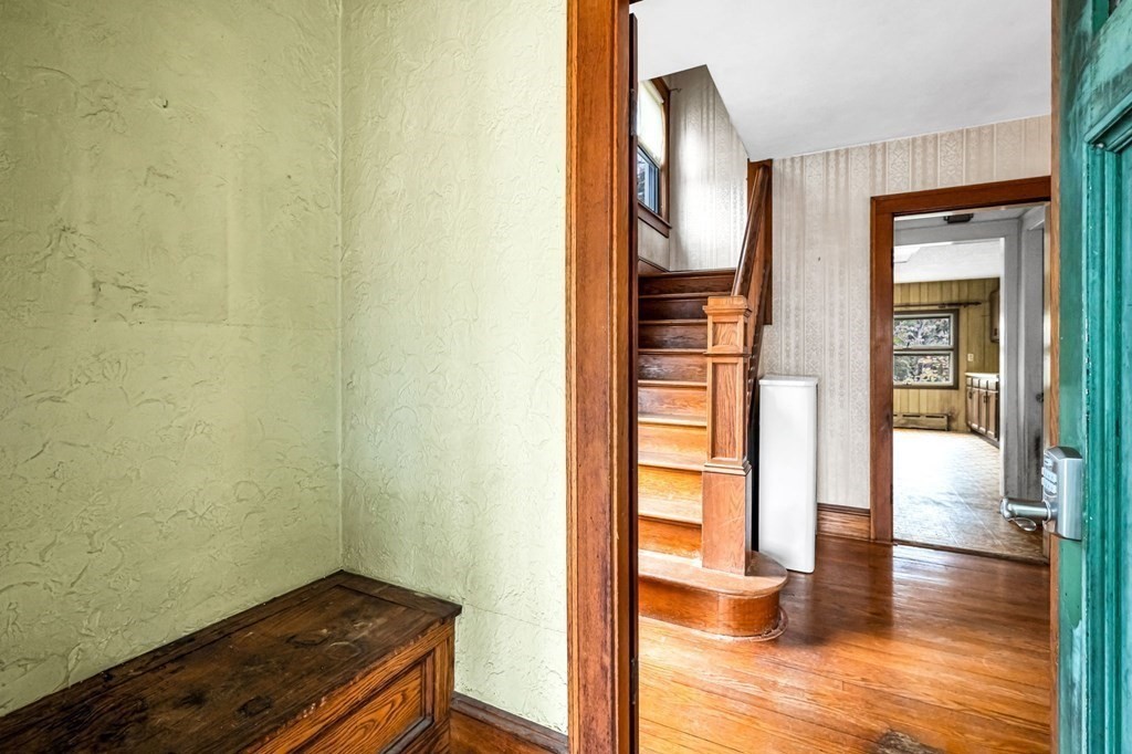 104 Eleanor Road Springfield, MA 01108 - Photo 17 of 33 a view of a hallway with wooden floor and a bathroom