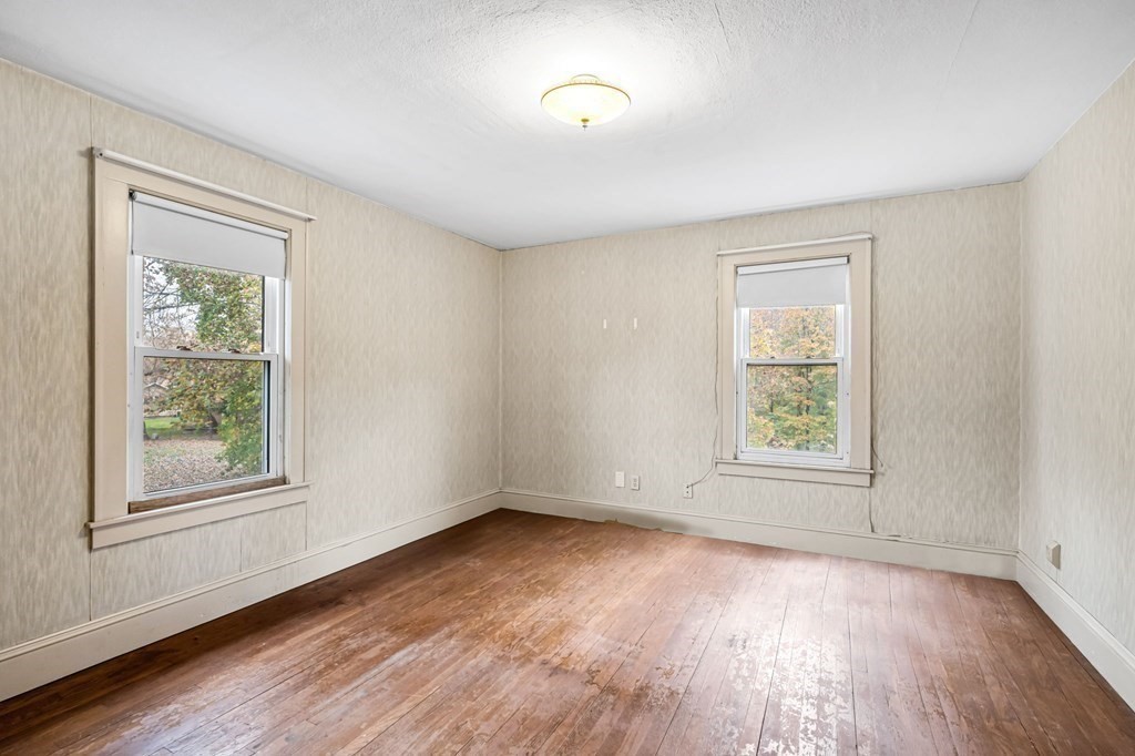 104 Eleanor Road Springfield, MA 01108 - Photo 18 of 33 an empty room with wooden floor and windows