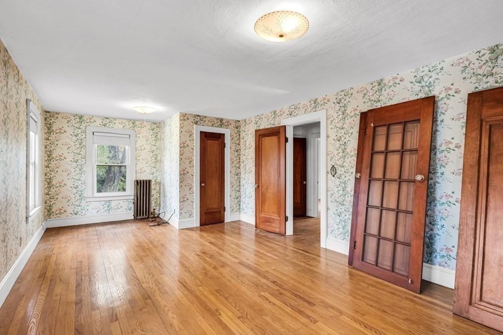 104 Eleanor Road Springfield, MA 01108 - Photo 21 of 33 an empty room with wooden floor and windows