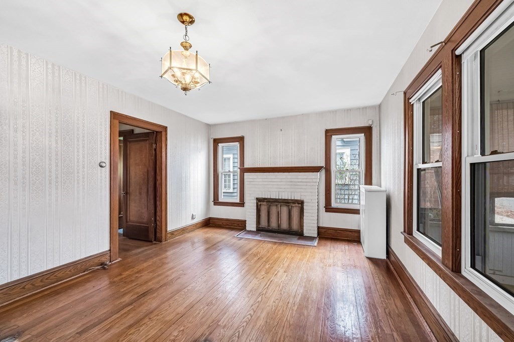 104 Eleanor Road Springfield, MA 01108 - Photo 5 of 33 a view of a livingroom with a fireplace wooden floor and a window