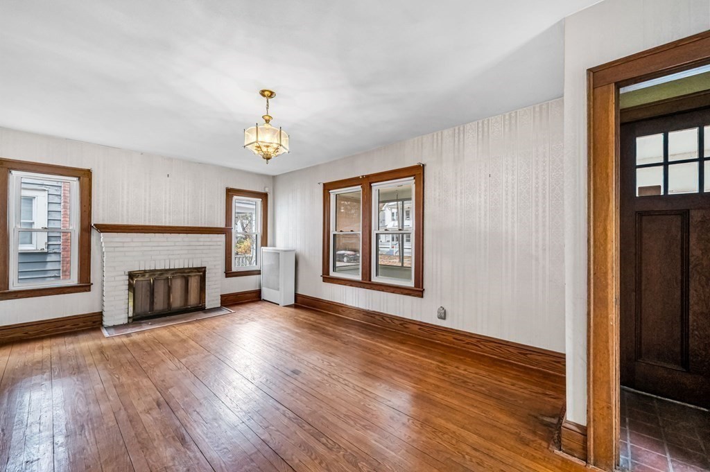 104 Eleanor Road Springfield, MA 01108 - Photo 6 of 33 wooden floor fireplace and windows in an empty room