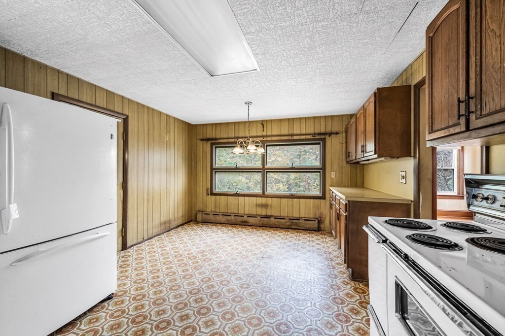 104 Eleanor Road Springfield, MA 01108 - Photo 8 of 33 a kitchen with a stove a refrigerator and a cabinets