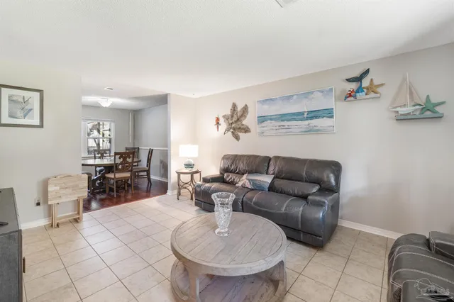 a living room with furniture and a kitchen view