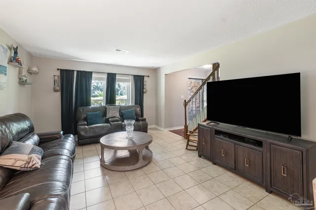 a view of a hallway with furniture and front door