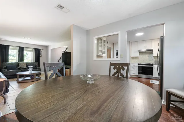 a kitchen with a refrigerator sink and cabinets