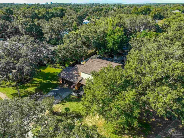 an aerial view of a house with a yard