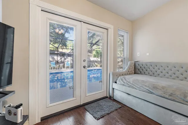 a bedroom with a bed and a flat screen tv