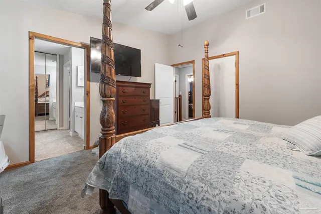 a bedroom with two beds and a chandelier